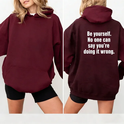 Fun hooded sweatshirt with slogan "Be yourself. No one can say you're doing it wrong"